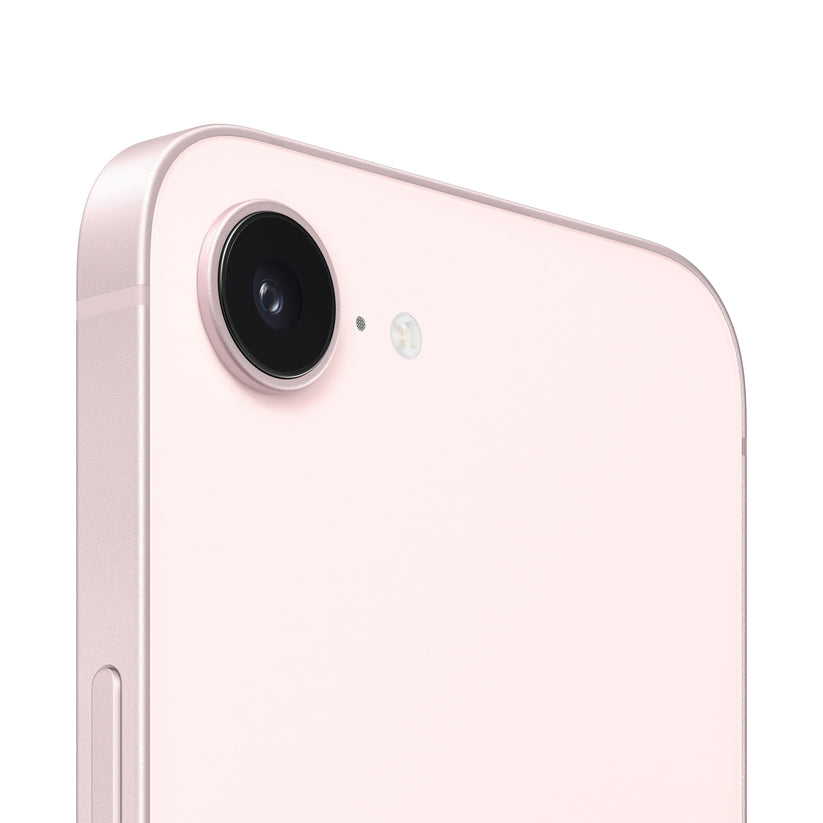 A close-up view of the pink smartphone's rear camera module, highlighting the single protruding lens, a tiny microphone hole, and the adjacent circular flash ring