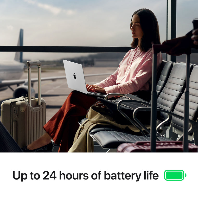 Woman traveling through an airport working on 14-inch MacBook Pro M5 Space Black with 24-hour battery life at Tradeline.
