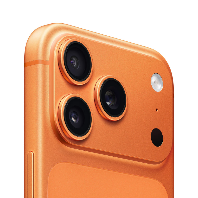 A close-up view of the rear camera module on the iPhone 17 Pro in Cosmic Orange, highlighting the triple-lens layout, flash, microphone, and raised housing design.